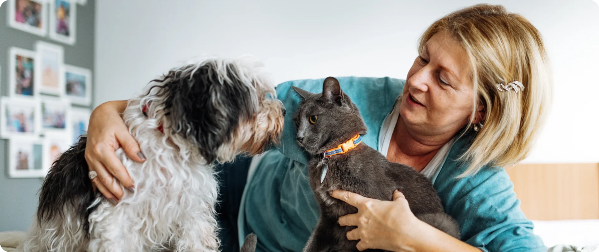 Woman with dog and cat on couch.